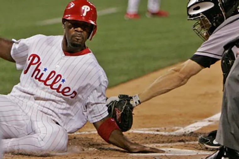 Jimmy Rollins scored a run after hurting his hamstring in Wednesday night's game. (Michael Bryant / Staff Photographer)