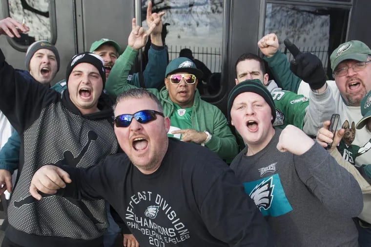 Eagles fans sing the fight song as they wait in line to enter the parking lot for an early morning tailgate party at Lincoln Financial Field. JOSE F. MORENO