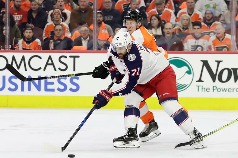 Flyers defenseman Robert Hagg tries to steal the puck from the Blue Jackets' Nick Foligno during a December game at the Wells Fargo Center.
