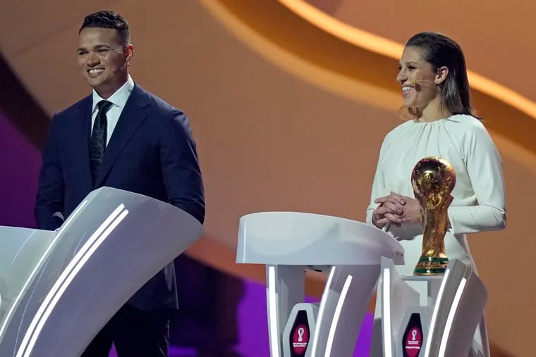 Delran's Carli Lloyd (right) was one of the celebrities at the draw for the FIFA men's World Cup in April.