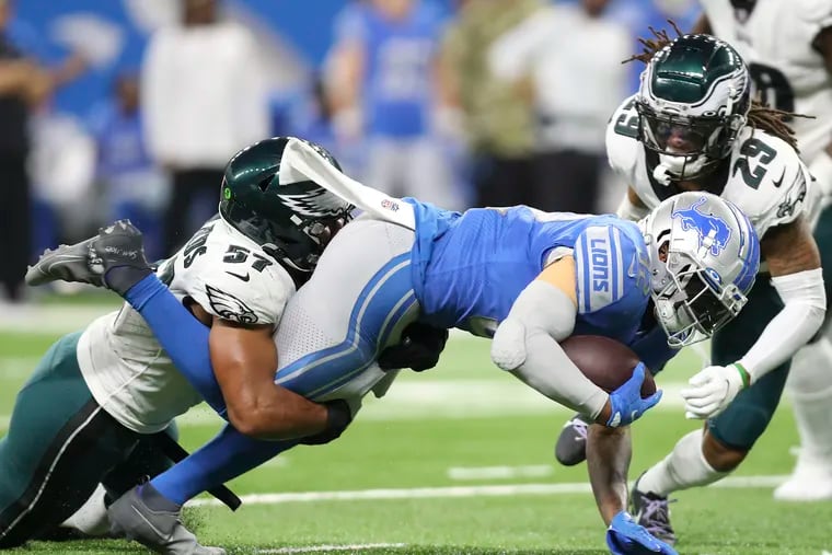 Eagles middle linebacker T.J. Edwards stops Detroit Lions running back D'Andre Swift with Eagles free safety Avonte Maddox during the second quarter.