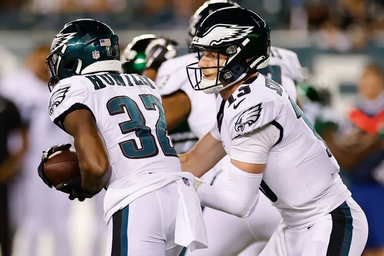 Eagles quarterback Reid Sinnett hands the ball off to running back Jason Huntley during a preseason game against the Jets on Aug. 12.