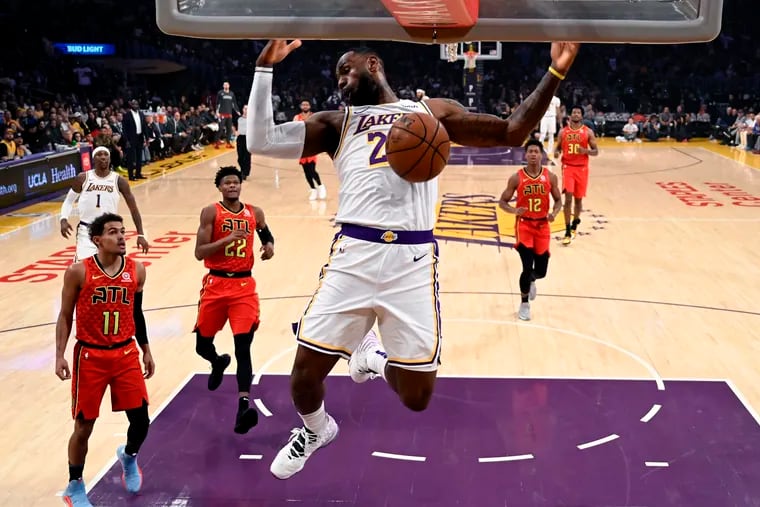 The Lakers’ LeBron James (23) dunking against the Atlanta Hawks during the first half Sunday.