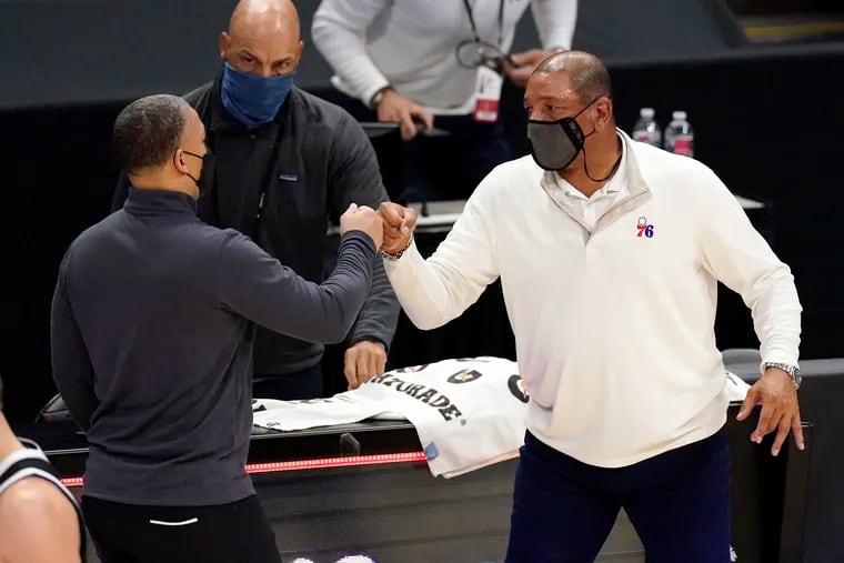 Los Angeles Clippers coach Tyronn Lue, left, and 76ers head coach Doc Rivers greeted each other after their March 27 game.