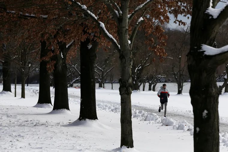 A runner in the snow along Kelly Drive in Philadelphia on Thursday, Dec. 17, 2020. Another storm could bring snow to the region early next week.
