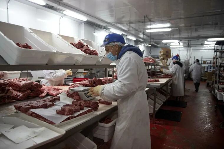 Employees work in the production facility at Purely Meat Co. in Chicago. The business had to let go of many of its 60 workers in the early days of the pandemic, but now has has recaptured 70% of its usual sales and has 40 employees working.