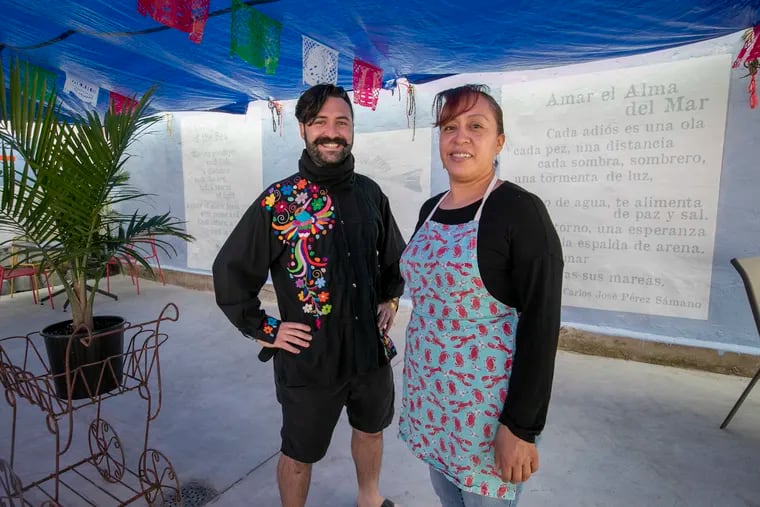 "To Love the Soul of the Sea" is the name of the poem that Carlos José Pérez Sámano unveiled in a mural on the patio wall of Alma del Mar restaurant, owned by Alma Romero de Tlacopilco (right), Wednesday, September 16, 2020.