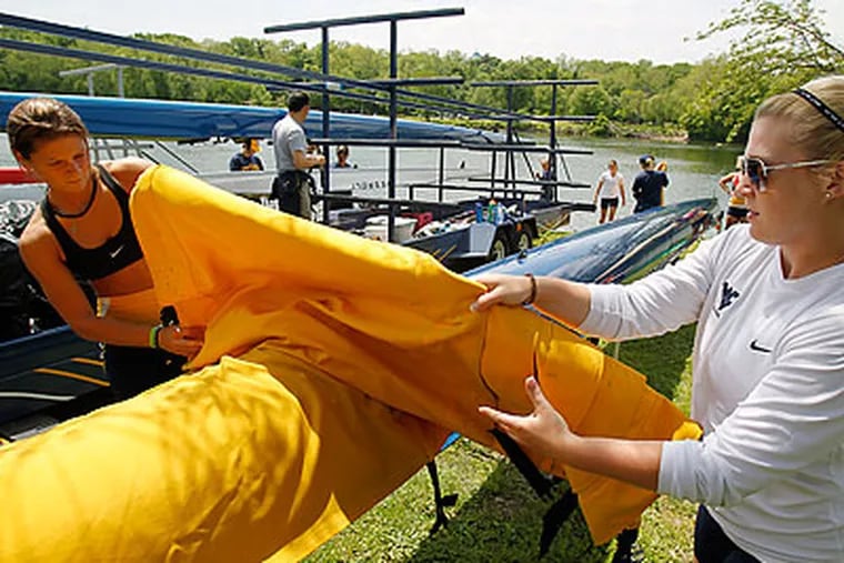 West Virginia rowers Hilary Meale (left) and Jenelle Spencer (right) get ready to head out to the river. (Akira Suwa/Staff Photographer)
