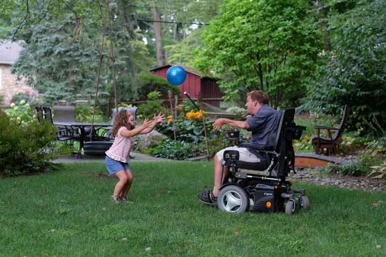 Elaina, 6, and Glen play catch in their back yard.