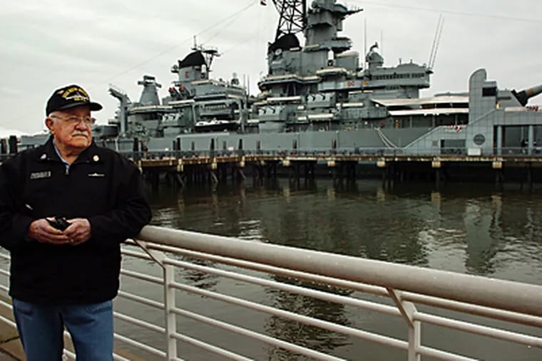 Docent, Dave Wetherspoon, waits for his tour group outside the Battleship New Jersey in Camden. The ship got a makeover and visitors will get new views of the ship. (Sharon Gekoski-Kimmel / Inquirer)
