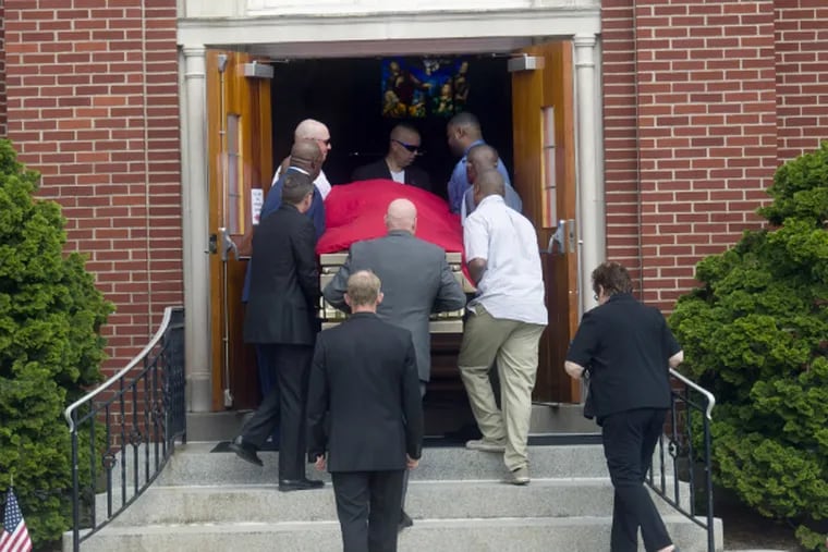 Pallbearers carry the casket into the viewing for NBA great Darryl Dawkins.