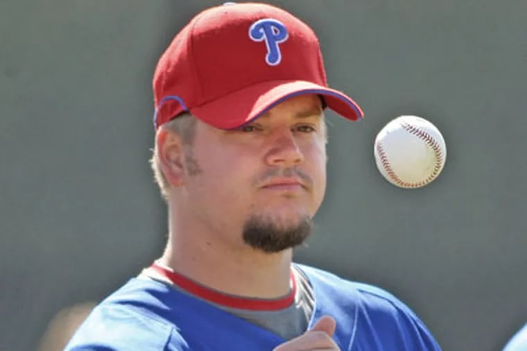 Phillies' pitcher Joe Blanton flips a ball while waiting his turn for drills during spring training at the Carpenter Complex in Clearwater, Fla., this week.  Blanton will start the Phils' first Grapefruit League game of the pre-season today. (Steven M. Falk / Staff Photographer)
