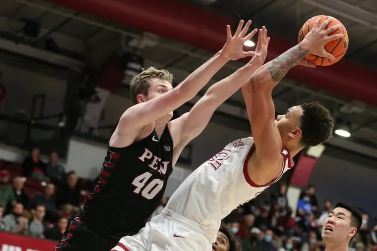 Jordan Hall of St. Joseph's shoots over George Smith, left, of Penn during the 2nd half of their game at Hagan Arena on Dec. 8, 2021.  Hall led all scorer's with 33 points.