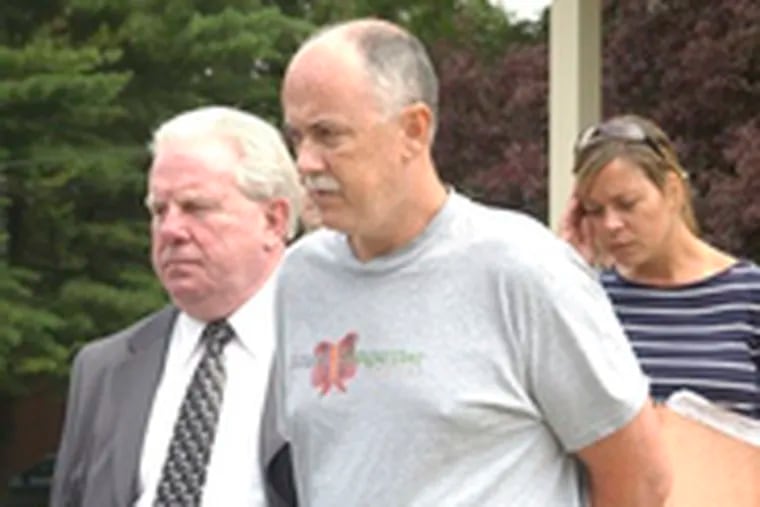 Steven J. Devlin (center) is led out of court after being charged with soliciting Internet sex.