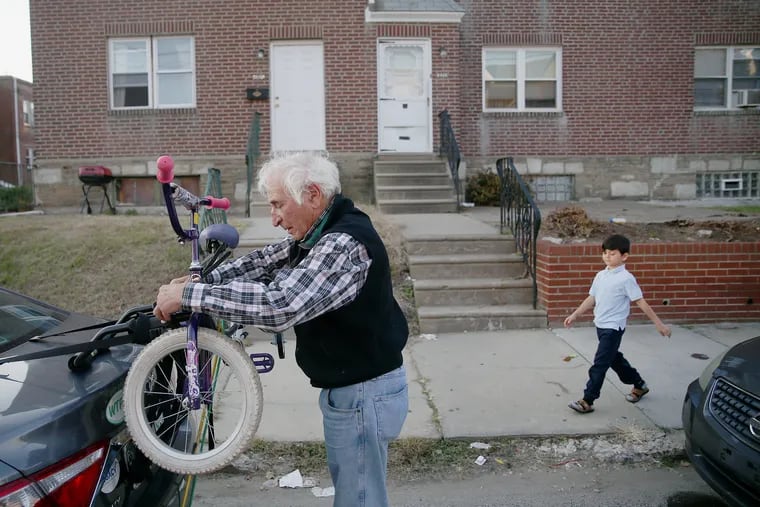HIAS volunteer David Broida brings a bicycle for Ebrahim, an 8-year-old from Afghanistan, to the boy's Northeast Philadelphia home.