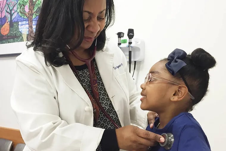 Dr. Tyra Bryant-Stephens listens to Kaydence Kardis breathing as part of a lung exam during a follow-up asthma visit last year.