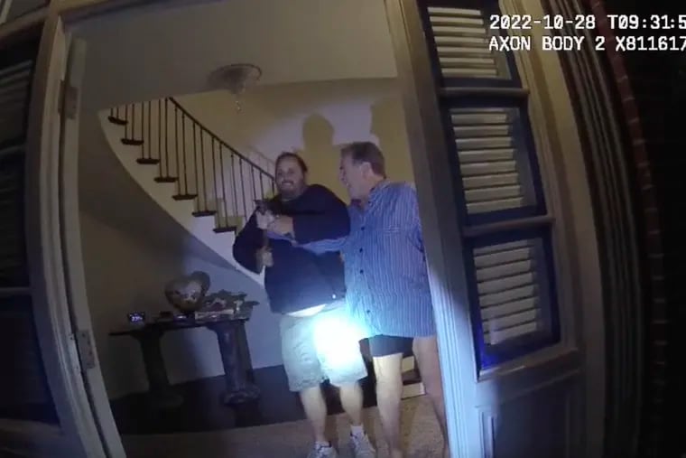 In this image taken from San Francisco Police Department body-camera video, the husband of former U.S. House Speaker Nancy Pelosi, Paul Pelosi, right, fights for control of a hammer with his assailant David DePape during a brutal attack in the couple's San Francisco home, on Oct. 28, 2022.