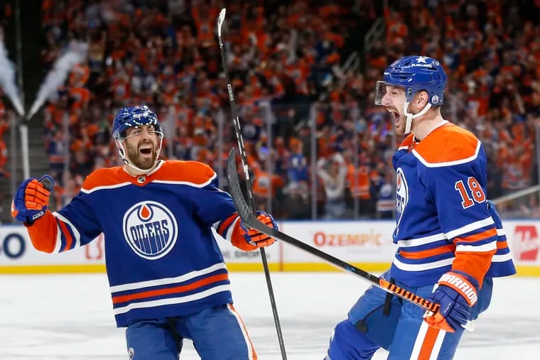 Zach Hyman #18 of the Edmonton Oilers celebrates a goal with Evan Bouchard #2 during the second period against the Vancouver Canucks in Game Six of the Second Round of the 2024 Stanley Cup Playoffs at Rogers Place on May 18, 2024 in Edmonton, Alberta. (Photo by Codie McLachlan/Getty Images)
