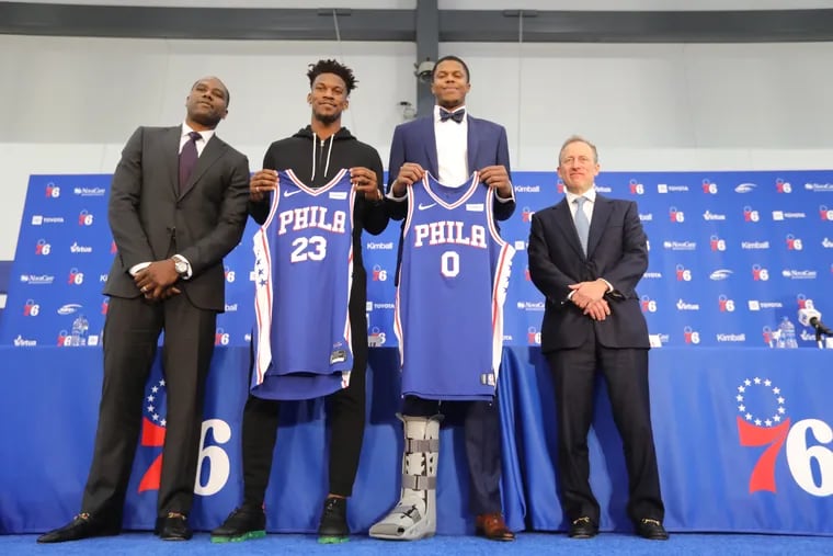 Jimmy Butler (left) and Justin Patton, the newest members of the Sixers, pose with general manager Elton Brand (far left) and co-managing partner Josh Harris on Tuesday. DAVID SWANSON / Staff Photographer