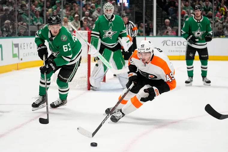 Flyers left wing Noah Cates (49) skates to take control of the puck in front of Evgenii Dadonov in the second period on Thursday in Dallas.