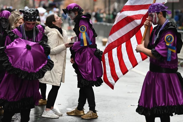 January 10, 2022: Alex Walker, 23, with the Misfits Comic Brigade, shares a moment with his girlfriend, Rachel Shur, 22, before he sets off with his fellow Mummers in the parade last Sunday.
