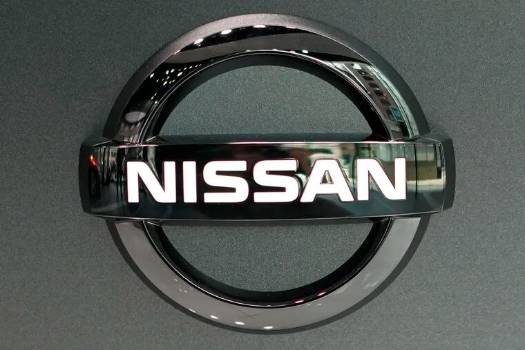 Nissan logo is seen at a Nissan car gallery Thursday, July 25, 2019, in Tokyo. Nissan says it will slash 12,500 jobs, about 9% of its global workforce, to cut costs, achieve turnaround toward growth.  (AP Photo/Eugene Hoshiko)