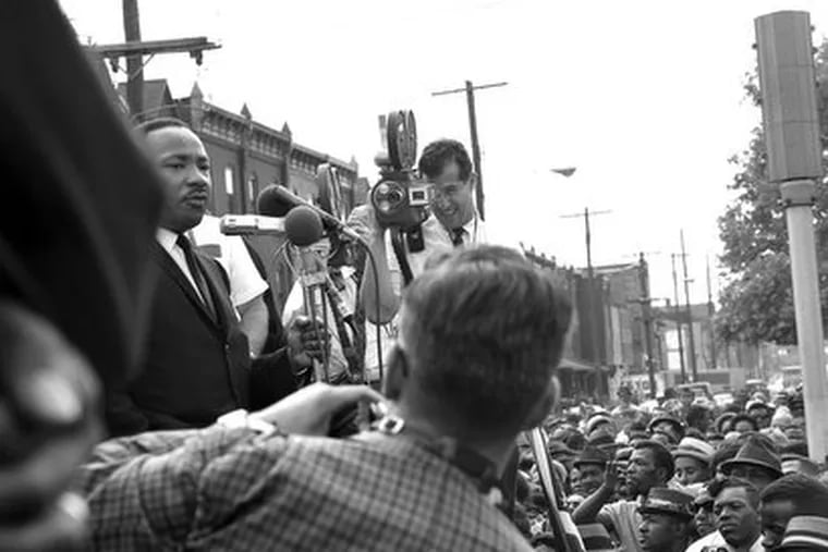 News cameras jostle for position as Martin Luther King Jr. speaks to a crowd at 40th and Lancaster Avenue in August 1965, as part of his Freedom Now tour.