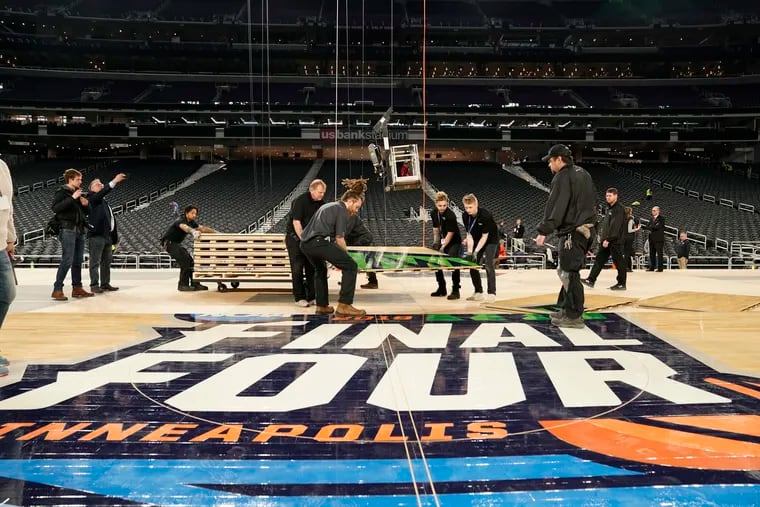 The operations crew work on preparing the court at U.S. Bank Stadium in Minneapolis.