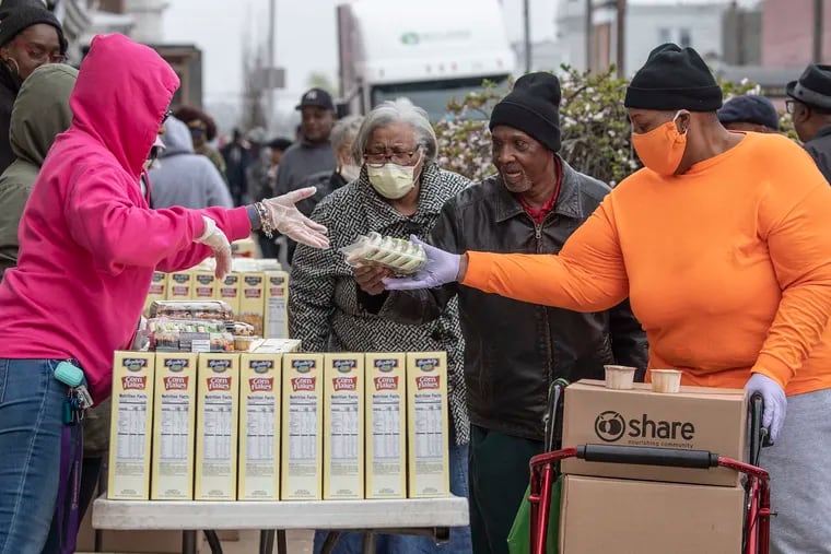 Philadelphia residents line up to receive  food donations last week at the Christian Compassion located at 6100 Cedar Ave, Philadelphia. The program is part of the Share Food Program, and Philabundance.