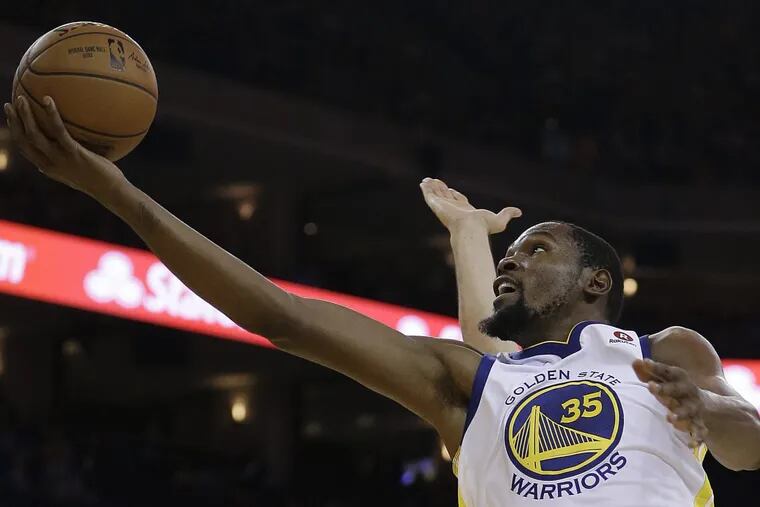 Warriors forward Kevin Durant lays up a shot against the Sixers on Saturday, Nov. 11.