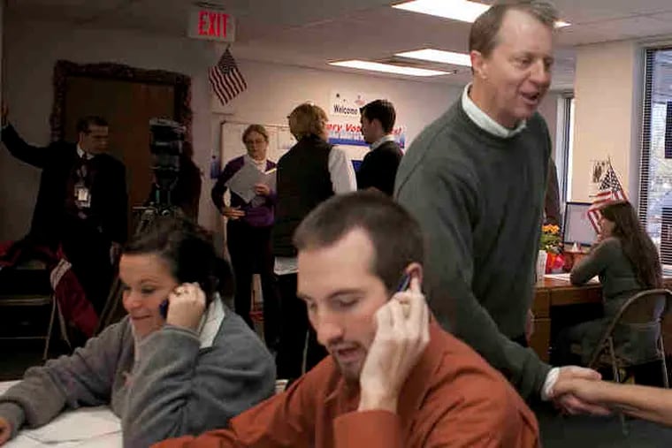U.S. Rep. John Adler visited his Marlton campaign headquarters Monday, shaking hands with Rich Locklear as others continued to work the phones.