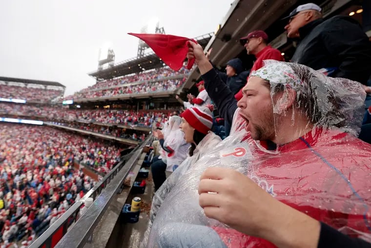 Phils fan Shane Gentile of Marlton cheers in the rain when the Phils get Padres Juan Soto out in the sixth inning. The Phillies won the National League Championship by defeating the San Diego Padres at Citizens Bank Park in Phila., Pa. on Sunday.