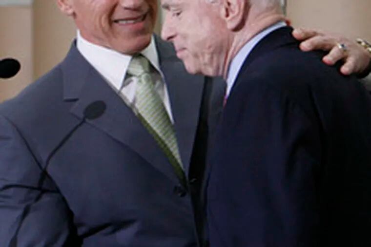 California Gov. Arnold Schwarzenegger shakes hands with Sen. John McCain, whom he endorsed in the GOP primary.