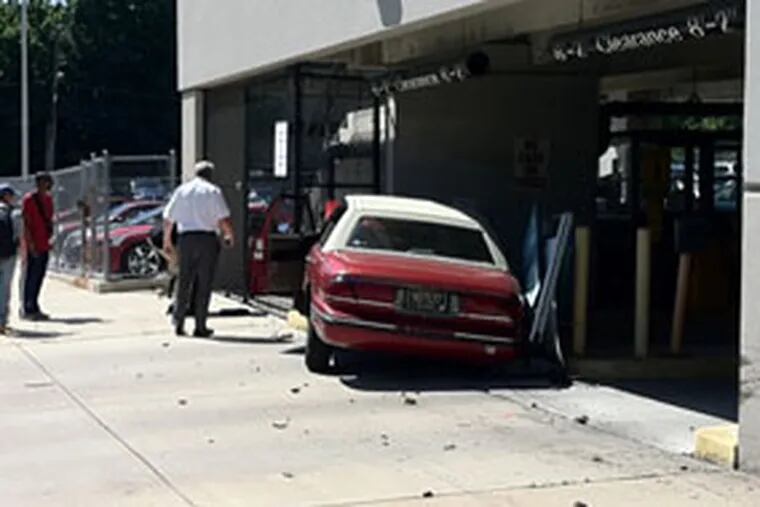 A red Buick LeSabre crashed into the cement wall of the parking garage. (ROBERT McGOVERN / Philly.com)