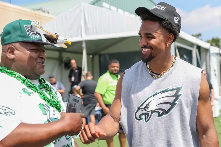 Philly superfan Lamont "Monty G" Anderson fist bumps Eagles quarterback Jalen Hurts in July at the NovaCare Complex in South Philadelphia.