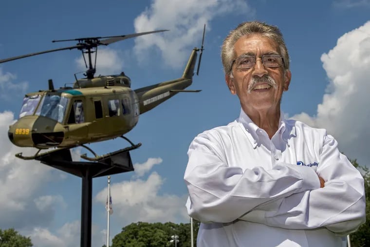 Ralph Storti poses with an actual Vietnam War-era Bell UH-1 Iroquois "Huey" helicopter in Willow Grove's Veterans Memorial Park July 26, 2018. Storti, a Vietnam War veteran, spent fourteen years working to realize his vision the memorial to honor members of all branches of the armed services.