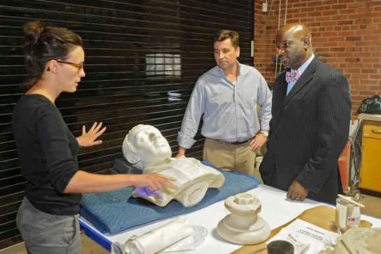 Alisa Vignalo of Milner + Carr explains the restoration process to the firm's John Carr (center) and the Rev. Mark Kelly Tyler.