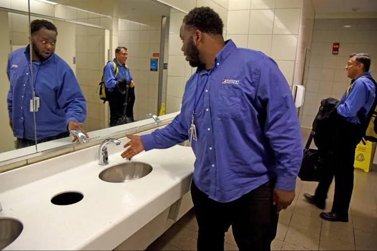 C.J. Mariney, of North Philadelphia, who works with Parkway at Philadelphia International Airport, checks on water pressure – finding none – in the restroom May 7, 2018 after a water main break under the parking lot shut down the water to all terminals.
