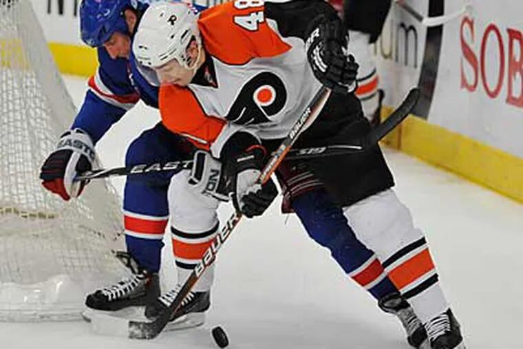 Philadelphia Flyers Danny Briere battles for the puck with New York Rangers' Vaclav Prospal. (AP Photo/Kathy Kmonicek)