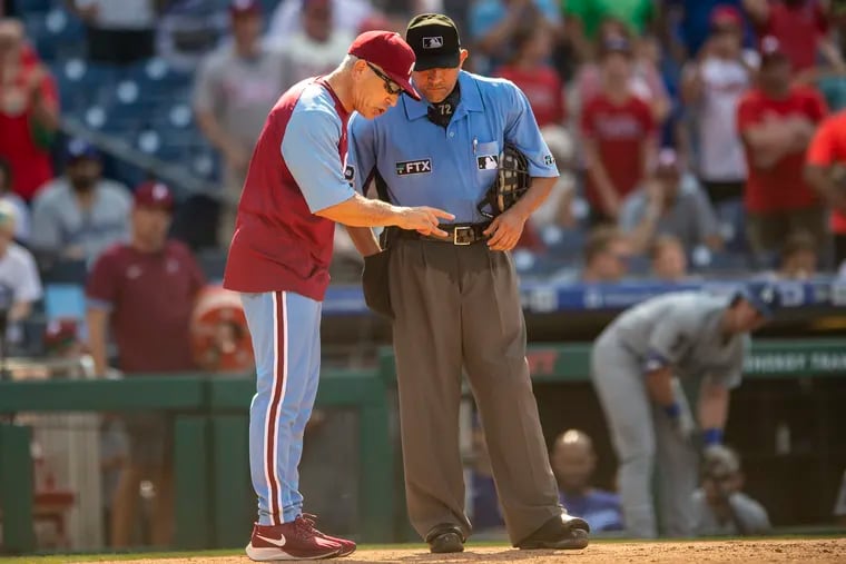 Phillies manager Joe Girardi argues with  umpire Alfonso Marquez during the ninth inning Thursday.