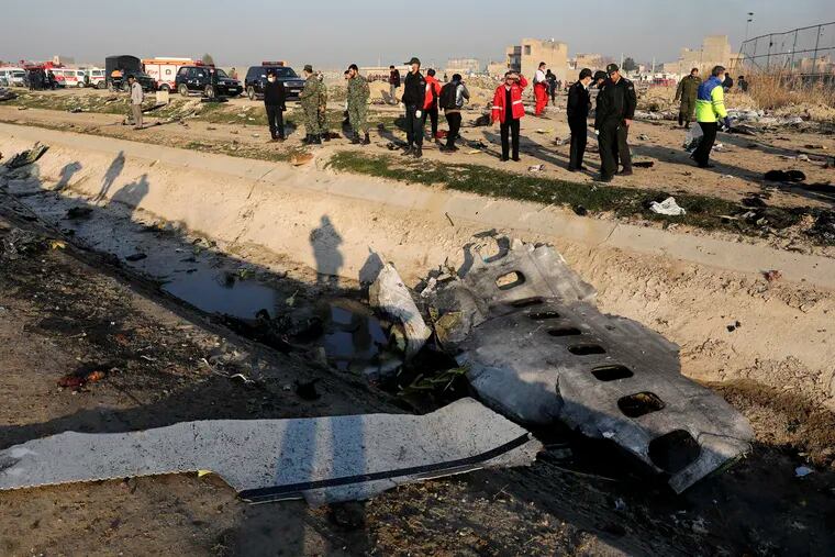 In this Jan. 8, 2020, photo, debris is seen from an Ukrainian plane which crashed as authorities work at the scene in Shahedshahr, southwest of the capital Tehran, Iran. Iran announced Saturday, Jan. 11, that its military “unintentionally” shot down the Ukrainian jetliner that crashed earlier this week, killing all 176 aboard, after the government had repeatedly denied Western accusations that it was responsible.