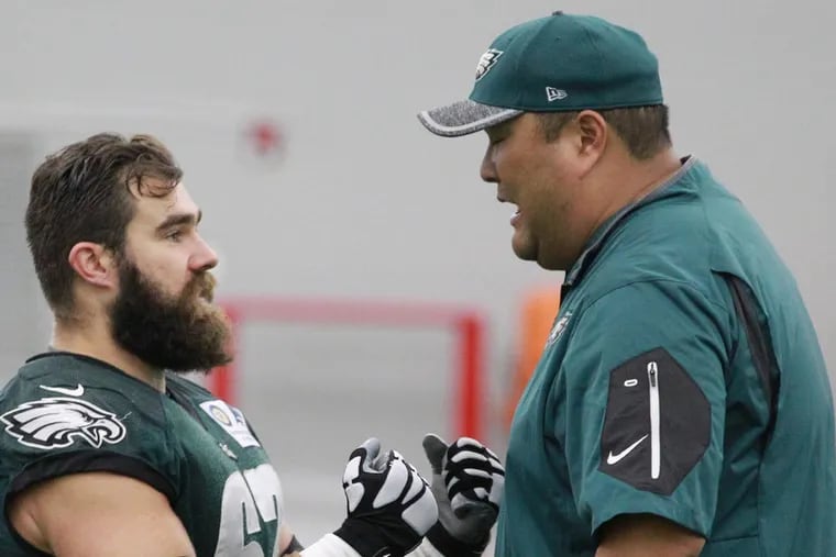 Eagles assistant coach Eugene Chung (right) talks to center Jason Kelce at practice in 2016.