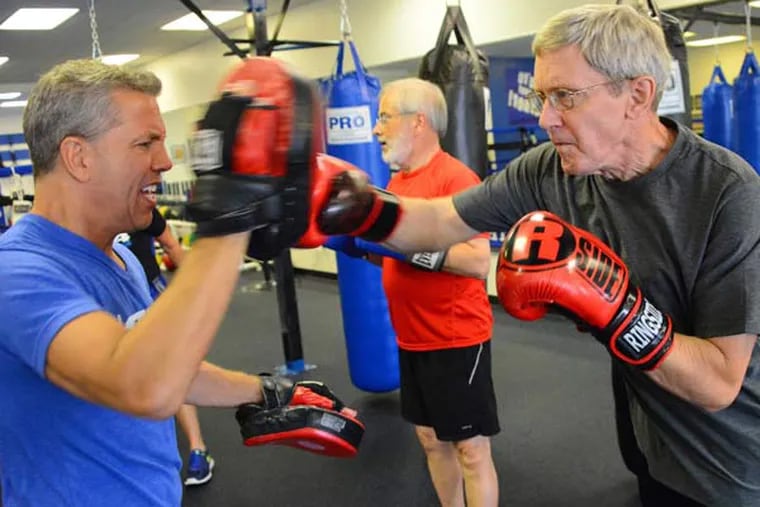 Rich Mushinsky left, owner of Fit 4 Boxing Club, practices with Dick Herchenroether, 64, on July 2, 2015 in Allison Park, Pa. The inaugural class of Rock Steady boxing is a non-contact boxing program for people with Parkinson's disease.