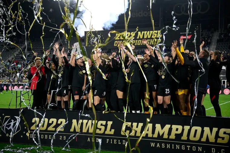 Portland Thorns players celebrate with the trophy after winning the NWSL championship game.