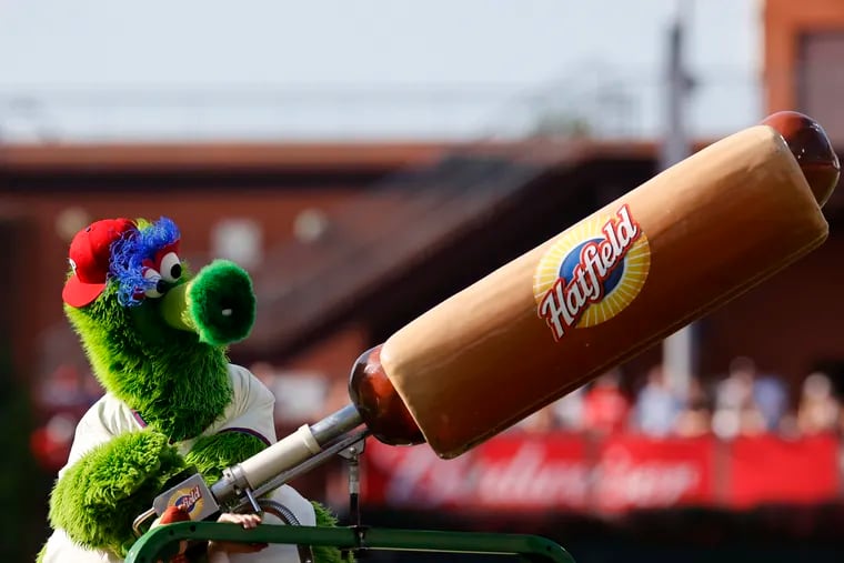 The Phillie Phanatic shoots hot dogs to fans during a break of a Phillies-Giants game in 2022.
