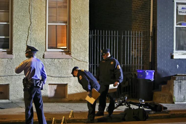 Police investigate the crime scene on Master Street near 51st Street, Thursday April 23, 2015, in West Philadelphia, after a Philadelphia police officer was wounded by gunfire. (Joseph Kaczmarek/For the Inquirer and Daily News)