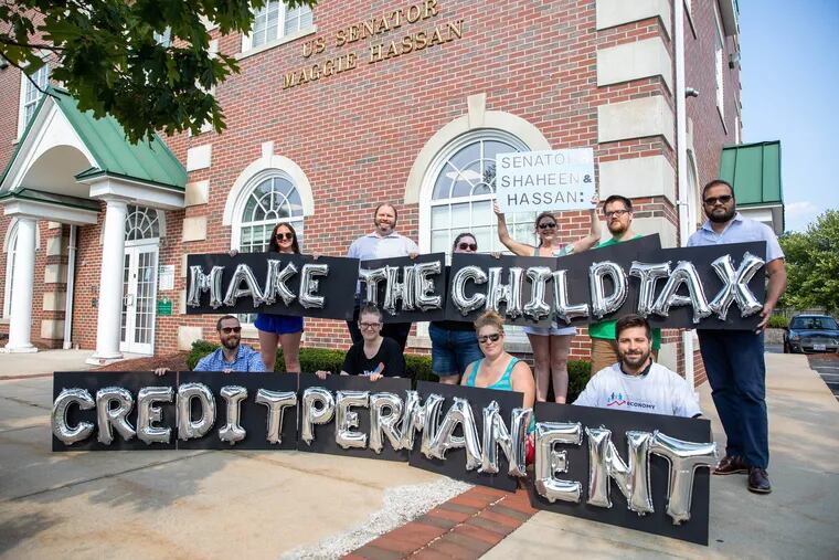 New Hampshire parents and other supporters outside of Sen. Maggie Hassan's Manchester office in September 2021 to demand child tax credits be made permanent.