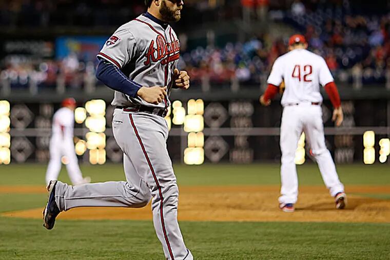 The Braves' Evan Gattis rounds the bases after hitting a home run off Phillies starting pitcher Cliff Lee in the fourth inning. (Matt Slocum/AP)