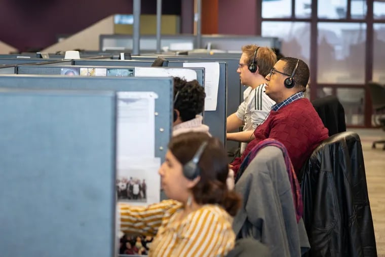 James E. Golden (center) works alongside colleagues at the call center at the Pennsylvania Higher Education Assistance Agency in Harrisburg, one of the largest servicers of federal student loans in America.