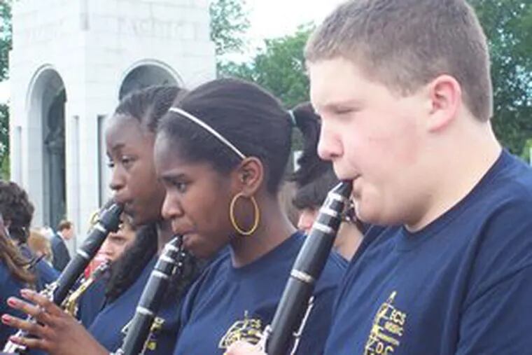 Eastampton Community School clarinetists (from left) Ruthie Gono, Melaiya Overton and Zachary Nasto play at the National World War II Memorial in Washington. Seventh and eighth graders from the school band and chorus performed patriotic selections last month.